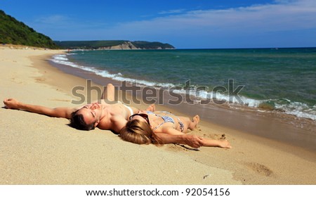 Young caucasian couple sunbathing at the beach