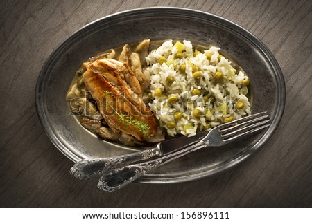 Chicken fillet with mushroom sauce and rice with pea