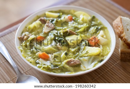 Cabbage soup with meat and potatoes close up