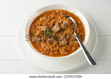 Cabbage stew with beef- goulash in white plate