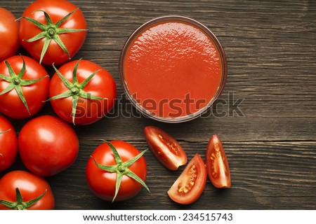 Fresh cherry tomato sauce on rustic wooden background