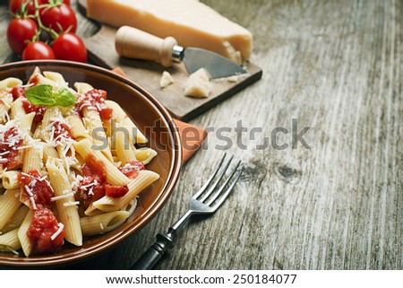 Plate of penne pasta with tomato sauce and parmesan cheese
