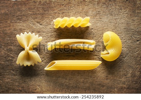 Raw pasta on wooden cutting board, close view