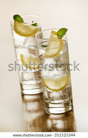 Two glasses of Fresh Mineral water with ice and lemon.