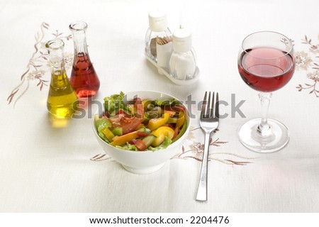 fresh salad on the table with wine oil and vinegar