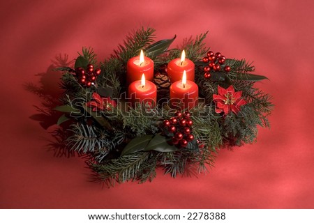 advent wreath on a red background close up