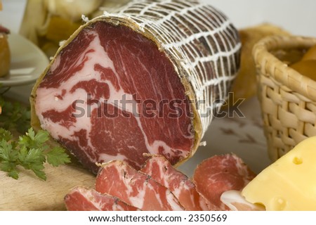 arranged prosciutto, cheese and bread  close up shoot