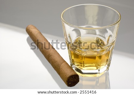 glass of whiskey and cigar close up on glass