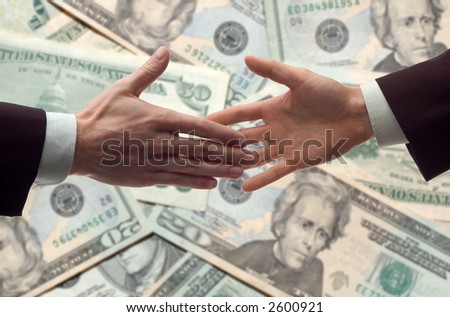 business handshake with money bills in background