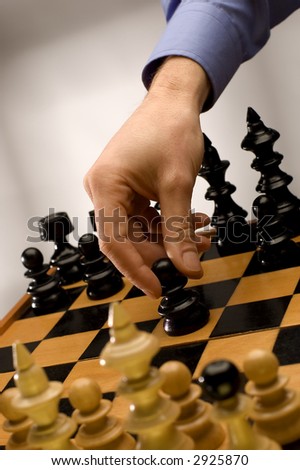 hand moving black chess figure close up