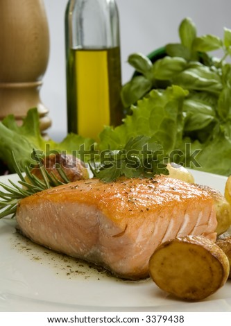 baked salmon steak with rosemary and potato on a plate