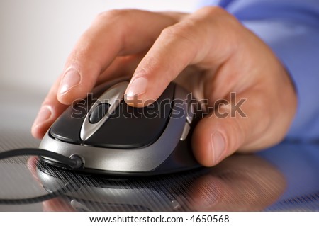 male business man hand on a computer mouse close up