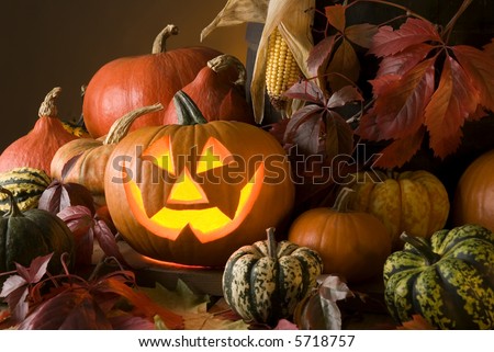 halloween pumpkin with autumn leaves close up