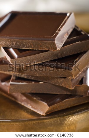 chocolate blocks on golden plate close up shoot