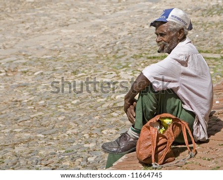 old men smoking cigar in trinidad- cuba