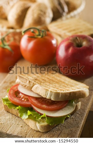 toast sandwich with salad, tomato and apple close up