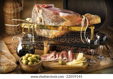 sliced prosciutto with red wine and olives close up shoot
