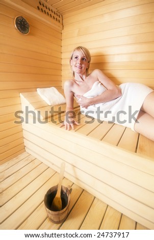 young blond woman relaxing in sauna close up