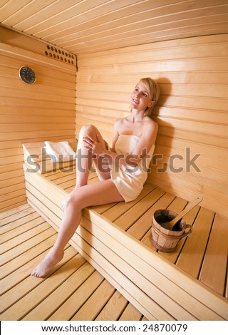 young blond woman relaxing in sauna close up