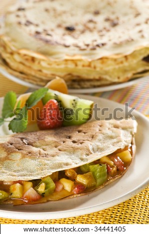 Pancake filled with mixed fruit close up shoot
