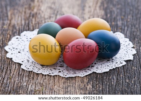 Colorful easter eggs on wooden background close up