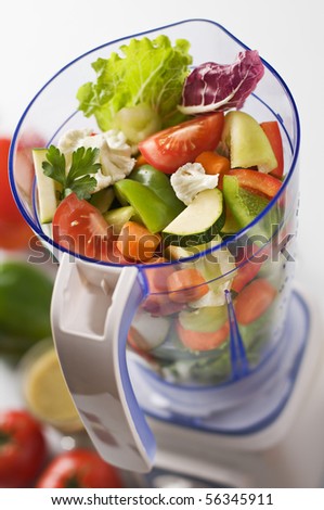 Sliced fresh vegetables in blender close up shoot