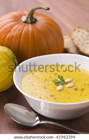 Fresh pumpkin soup with parsley close up