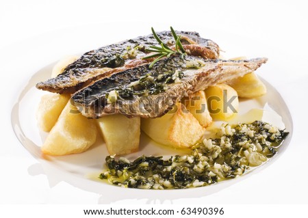 Fresh mackerel fillet with baked potato close up