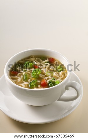 Fresh hot soup with noodles and vegetables close up