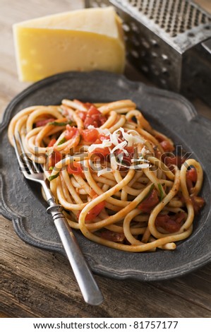 Fresh spaghetti with tomato sauce on a plate close up