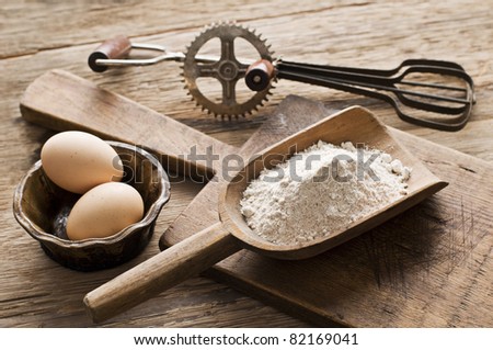 Flour and eggs on wooden background - vintage
