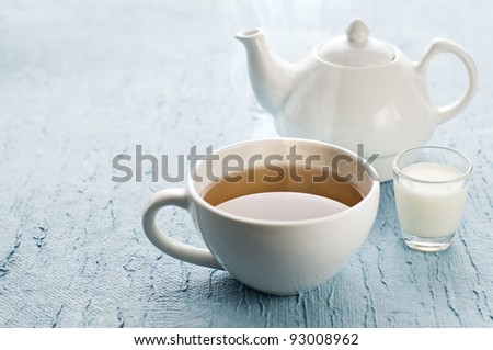 Cup of hot tea with milk close up shoot