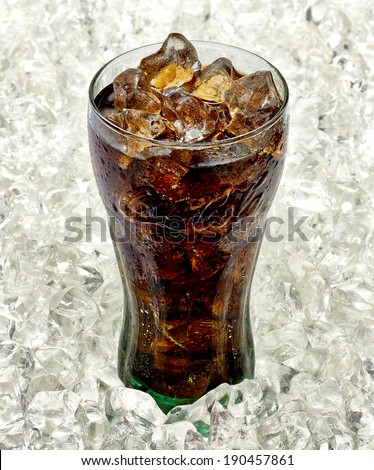 TURKEY - May 02, 2014: Coca-Cola glass with water drops on ice in close up. Coca-Cola is one of the worlds favorite beverages.
