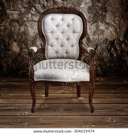 Grunge style interior with antique armchair under dramatic lighting