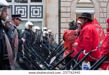 BRUSSELS - DECEMBER 15: National General Strike on December 15, 2014 in Belgium. Unions protesting against reforms proposed by Michel Government are confronted by riot police on Rue Royale, Brussels.