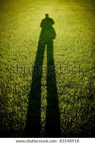 man shadow on grass