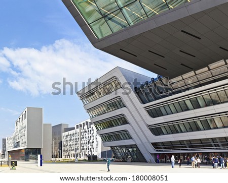 VIENNA, AUSTRIA - MARCH 2: Some People and Students in front of the new and  futuristic University of Economics and Business on March 2, 2014 in Vienna, Austria. Design by famous architect Zaha Hadid.
