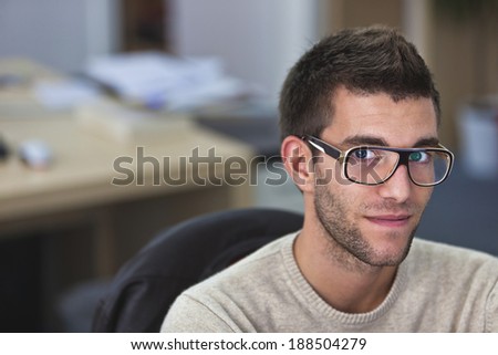 Real People - Portrait of a smart an handsome young man in office with available light