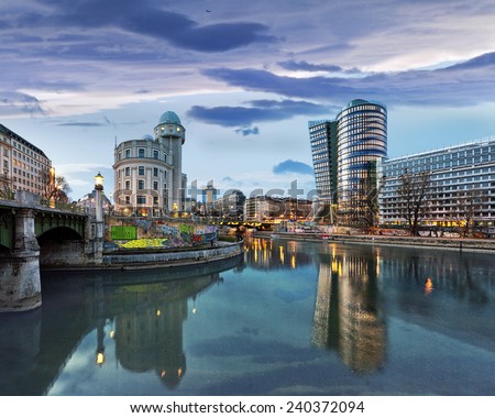 Donaukanal (Danube Canal) of Vienna, Austria. At the right the new UNIQA-Tower and opposite the historic building Urania, a public educational institute and observatory.