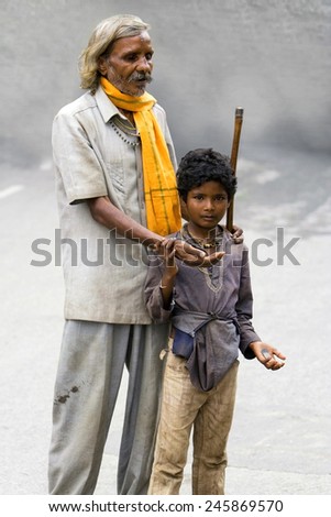 UDAIPUR, INDIA - SEPTEMBER 11: An unidentified blind man begging for money with the help of an young boy in the streets on September 11, 2008 in the streets of Udaipur, India