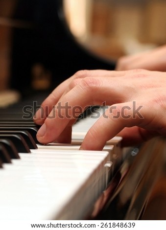 Hands of a piano playing musician in a sensitive mood