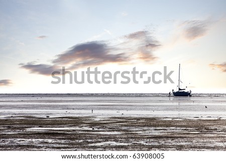 family sailboat stranded on tideland