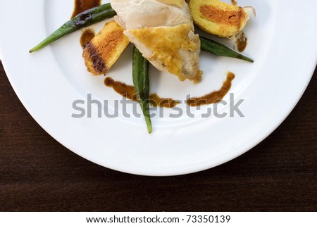 okra with white meat, like chicken for example, arranged on a table of mahogany - ala fine cuisine