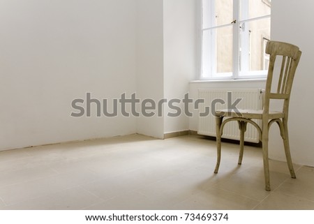 one lonley chair in a apartment which seemed to be abandoned.