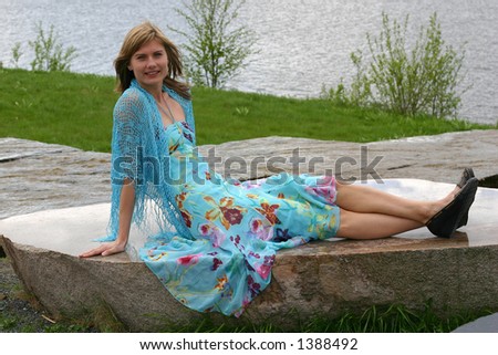 Cute girl posing on a flat rock
