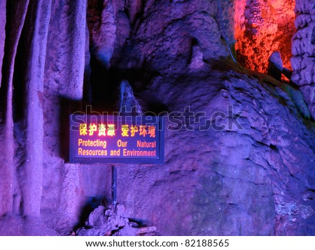 Stalactite with a sign board saying protect the environment