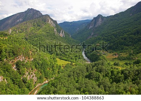 A beautiful view of the Canyon of the Tara river with a settlement at the bottom and some lines crossing the canyon. Montenegro.