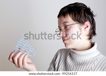 A young girl with a diamond molecule in her hand
