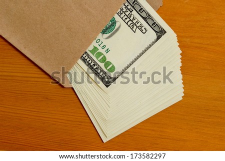Tutu dollars in cash in a paper envelope.