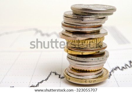 Coins from different countries, stacked in the financial schedule.